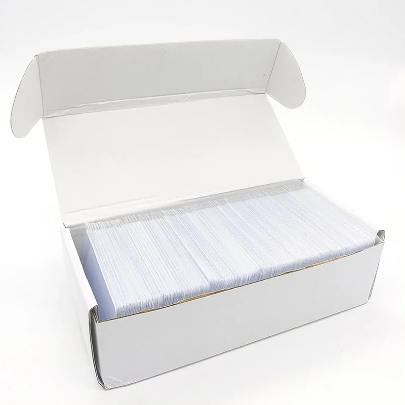 Blank NTAG215 NFC cards, white PVC, packs of 50 or 100 — representative supplier photograph