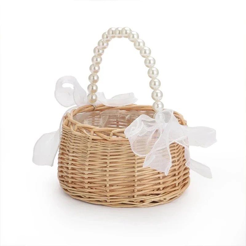 Wicker flower girl basket with pearl-bead handle and bow — representative supplier photograph
