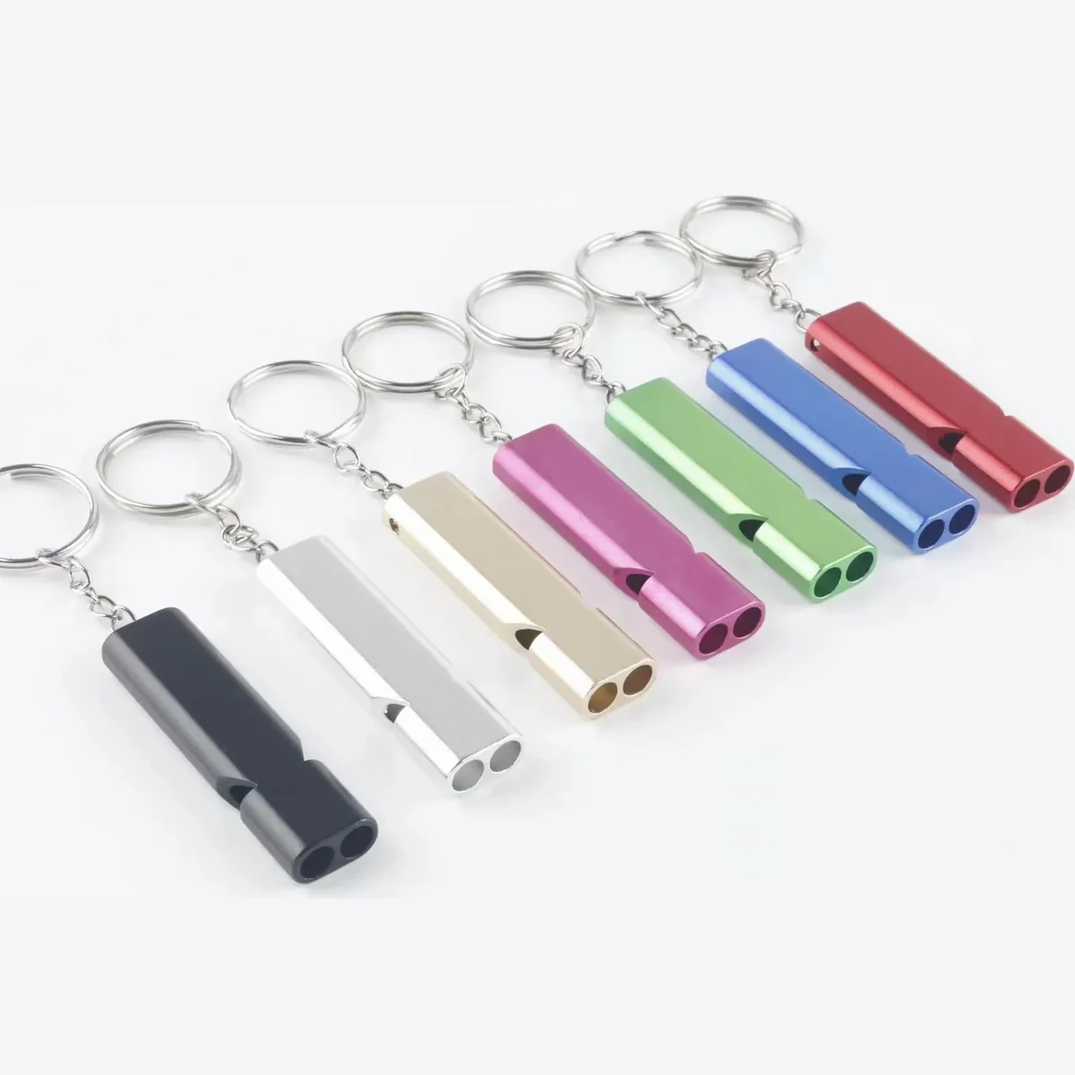 Double-tube aluminium whistle keychain — representative supplier photograph