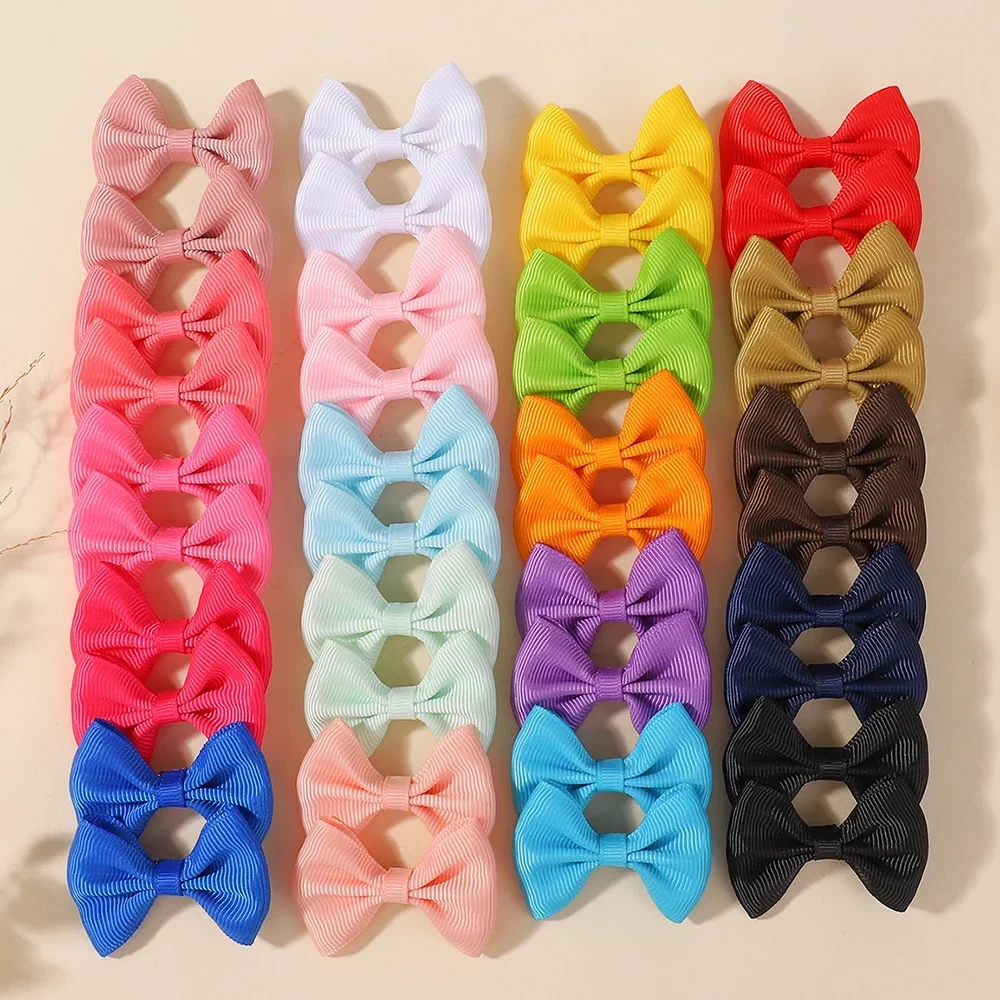 Small ribbon bow hair clips in assorted colours, packs of 20 to 40 — representative supplier photograph
