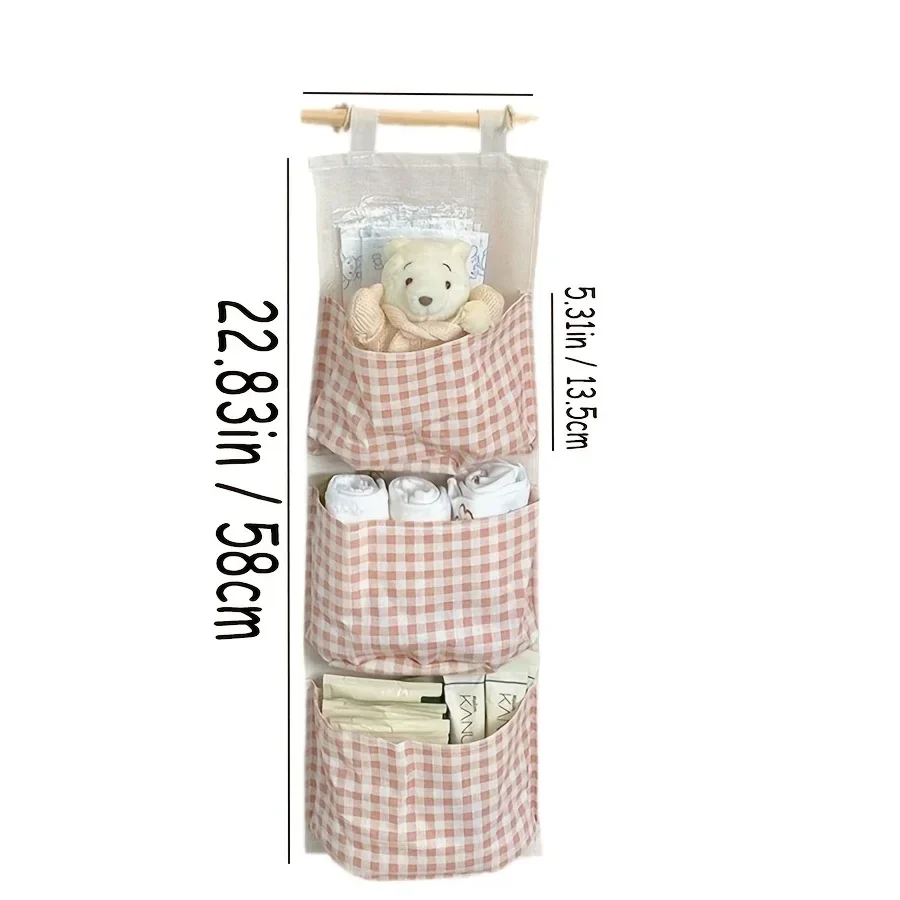 Hanging canvas wall organiser with three pockets — representative supplier photograph