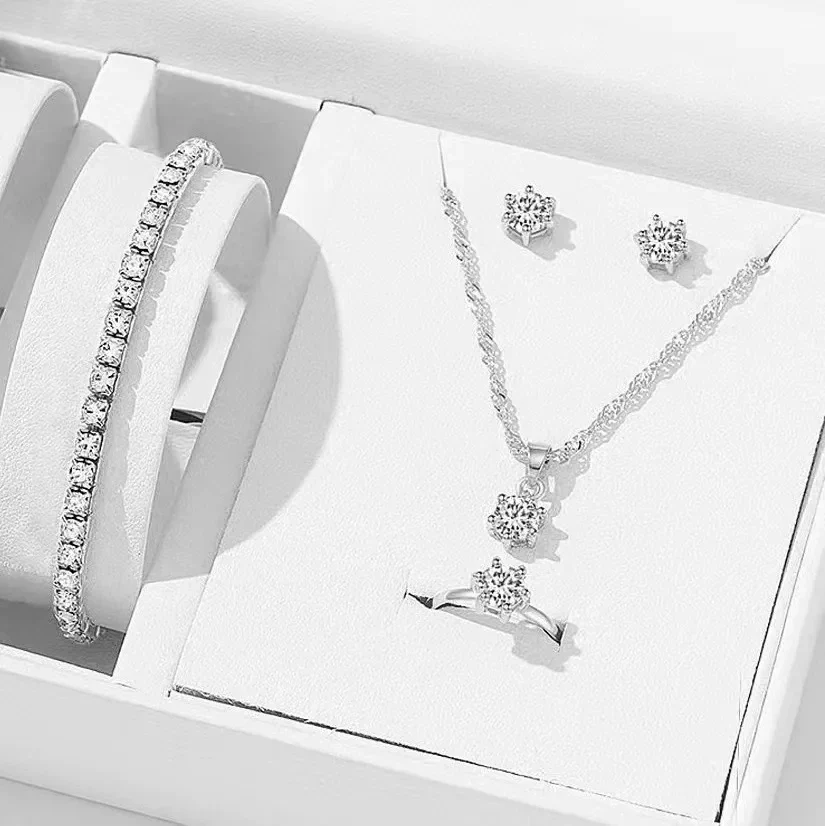 Five-piece crystal-style jewelry set: necklace, bracelet, ring and earrings — representative supplier photograph