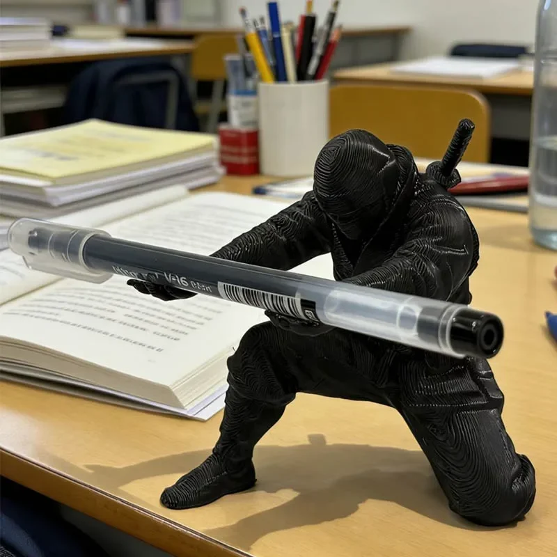 Crouching ninja pen holder, black desk figure — representative supplier photograph