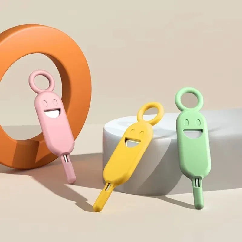 SIM tray eject pin with silicone card holder and key ring loop — representative supplier photograph