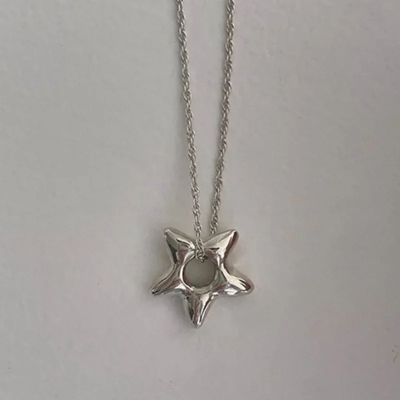 Hollow star pendant necklace on a fine chain — representative supplier photograph