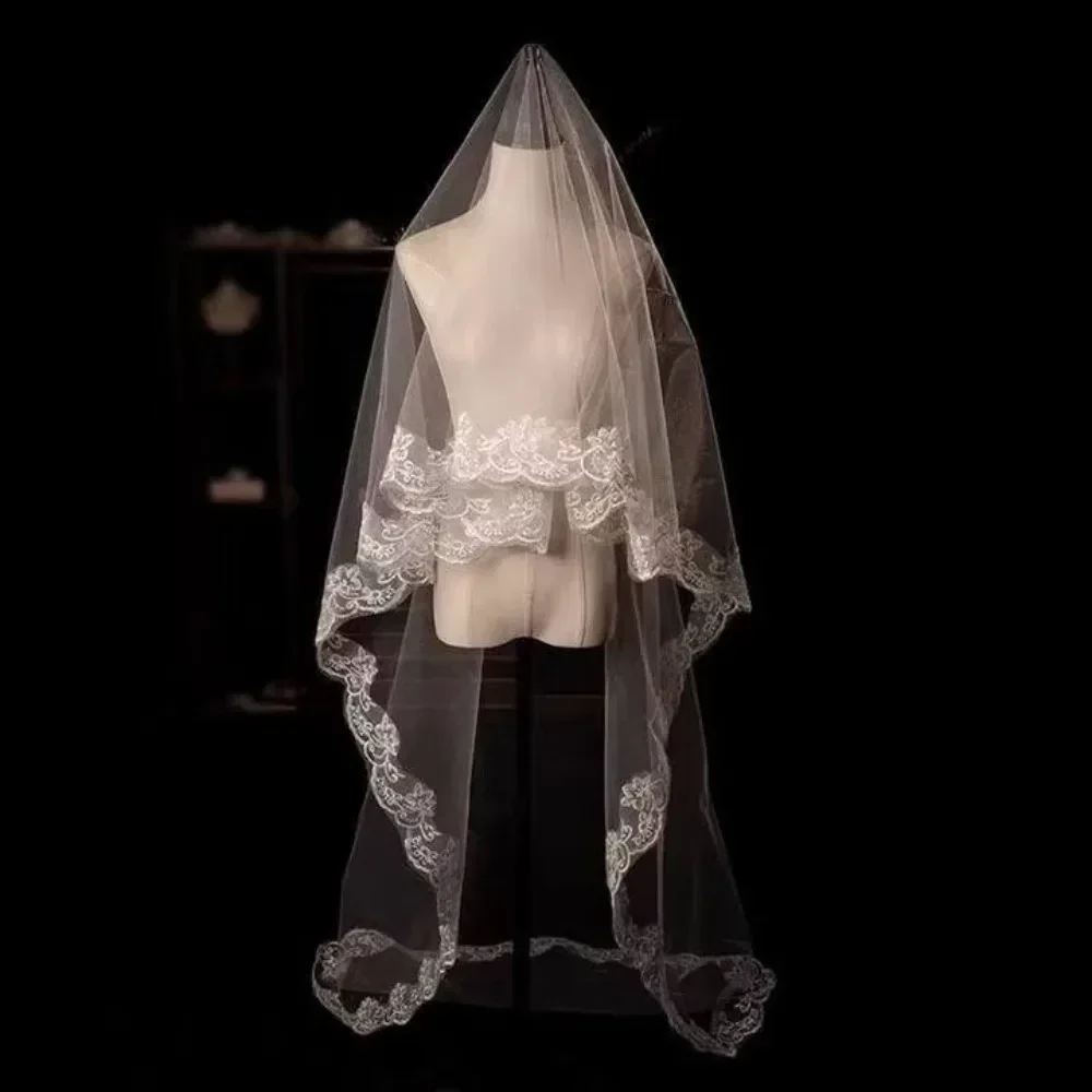 Single-layer tulle bridal veil with lace flower edge, white — representative supplier photograph