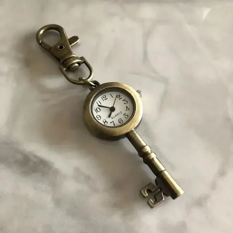 Vintage key-shaped pocket watch with chain and clip — representative supplier photograph