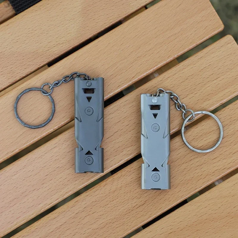 Double-barrel stainless steel survival whistle with key ring — representative supplier photograph
