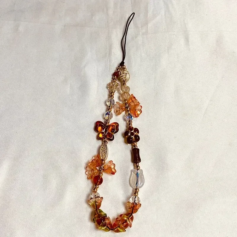 Beaded phone charm wrist strap, vintage style — representative supplier photograph