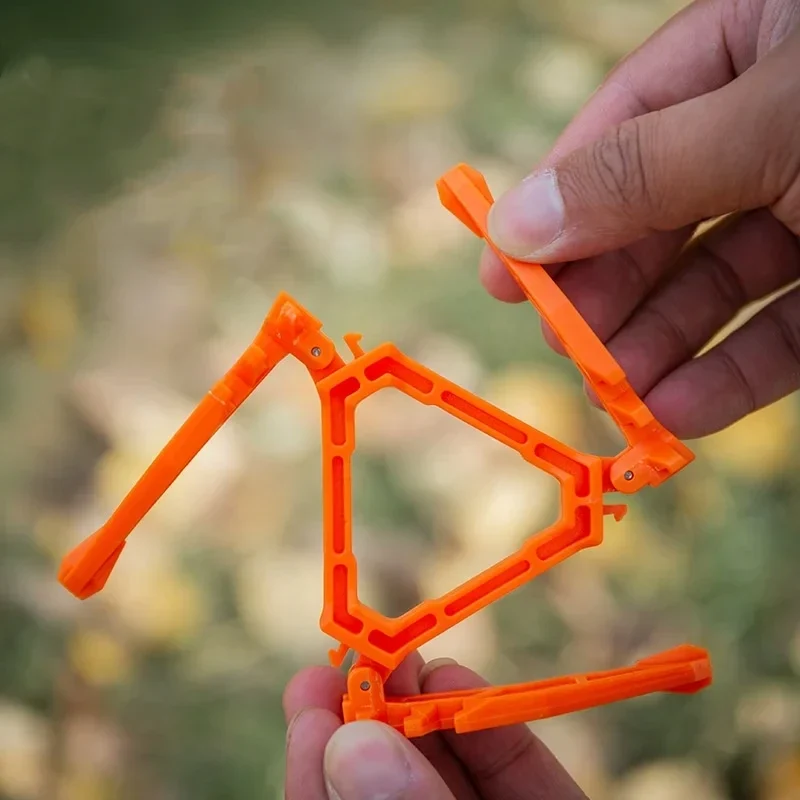 Folding gas canister stand for camp stoves, orange — representative supplier photograph