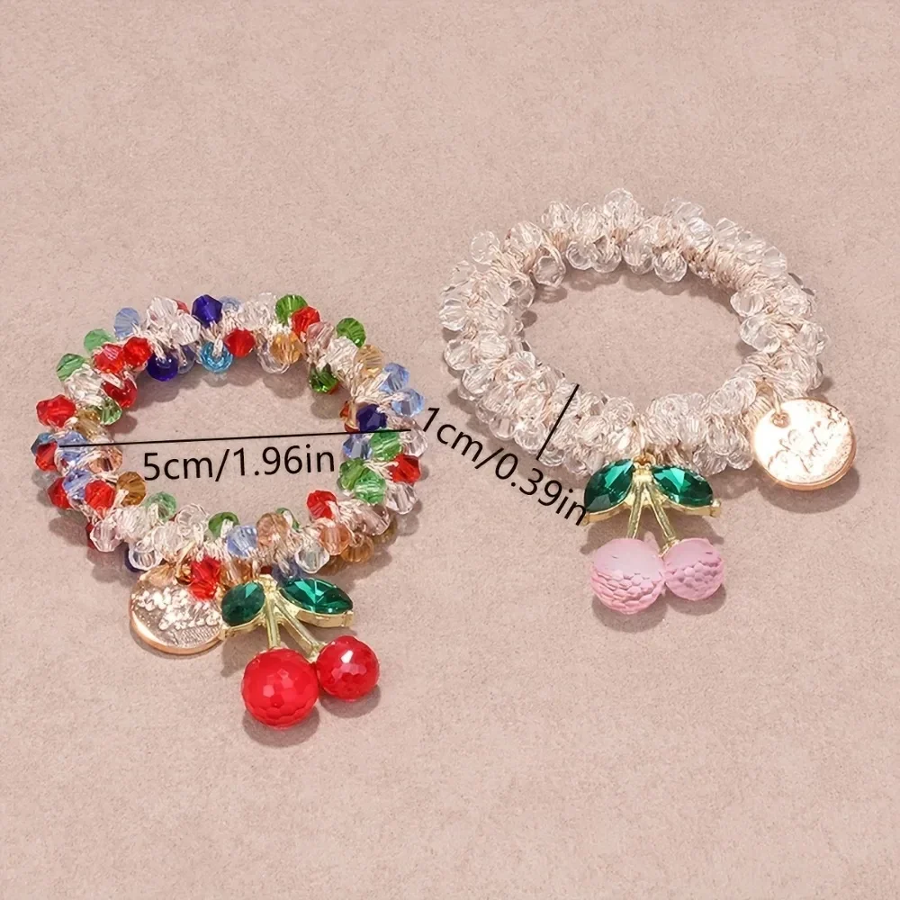 Crystal bead hair tie with cherry charm, doubles as a bracelet — representative supplier photograph