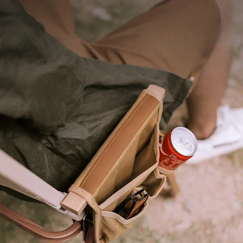 Camping chair armrest organizer with pockets and drink holder — representative supplier photograph